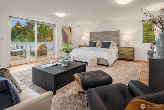5802 43rd Ave NE, Seattle, WA 98105 - bedroom featuring access to exterior, wood finished floors, and baseboards