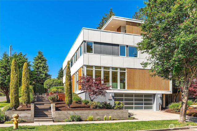 5802 43rd Ave NE, Seattle, WA 98105 - view of front of property featuring stairway, an attached garage, and driveway