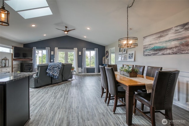 184 S Razor Clam Dr SW, Ocean Shores, WA 98569 - dining area featuring wood finished floors, a skylight, lofted ceiling, a chandelier, and a ceiling fan