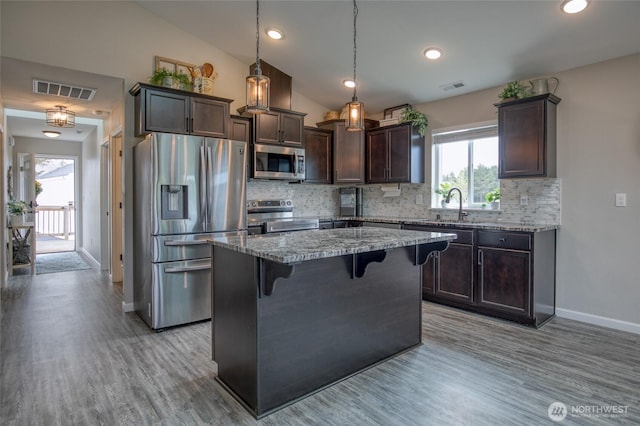 184 S Razor Clam Dr SW, Ocean Shores, WA 98569 - kitchen featuring stainless steel appliances, dark brown cabinets, baseboards, backsplash, and light wood-style floors