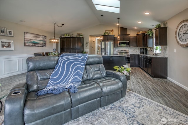 184 S Razor Clam Dr SW, Ocean Shores, WA 98569 - living area featuring a skylight, dark wood finished floors, lofted ceiling, and baseboards