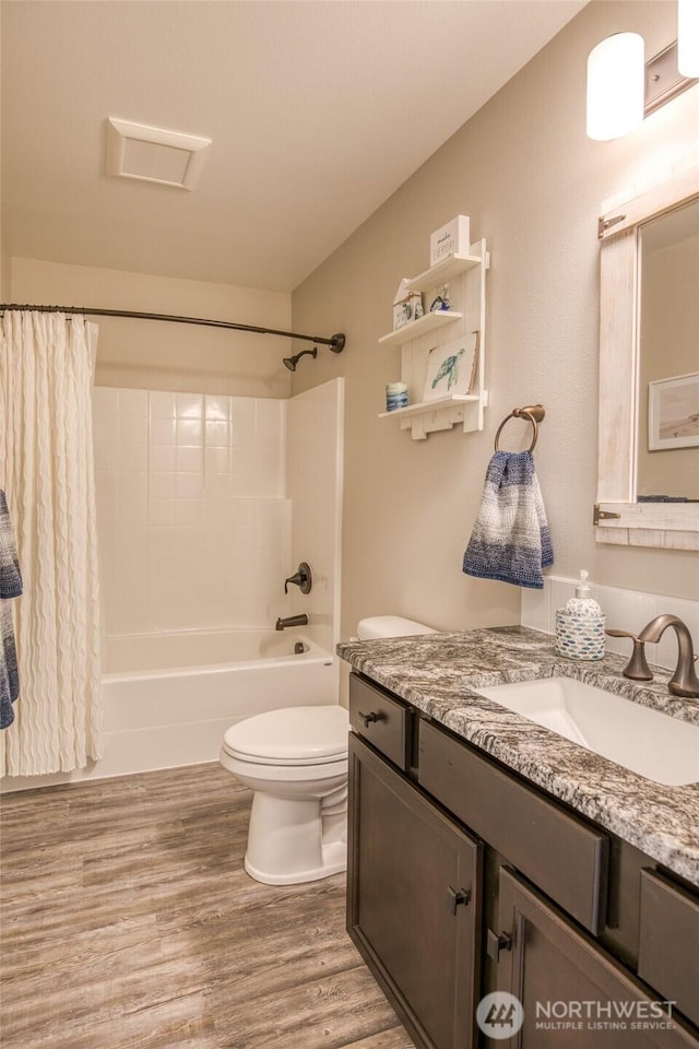184 S Razor Clam Dr SW, Ocean Shores, WA 98569 - bathroom featuring toilet, wood finished floors, vanity, and shower / bath combo