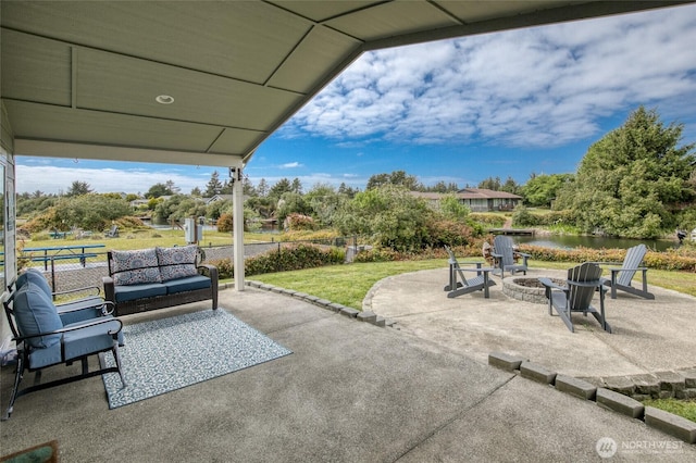 184 S Razor Clam Dr SW, Ocean Shores, WA 98569 - view of patio / terrace with a water view and an outdoor living space with a fire pit