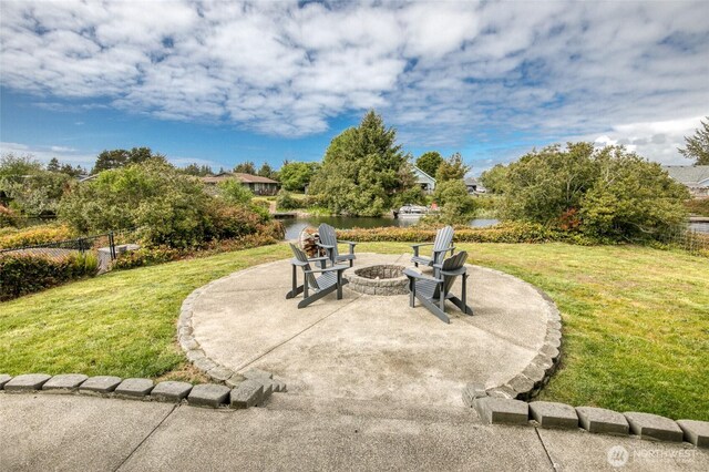 184 S Razor Clam Dr SW, Ocean Shores, WA 98569 - view of patio featuring a fire pit and a water view