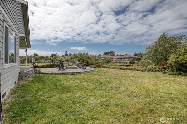 184 S Razor Clam Dr SW, Ocean Shores, WA 98569 - view of grassy yard with an outdoor fire pit and a patio