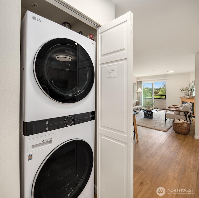 9057 Greenwood Ave N Unit 201, Seattle, WA 98103 - laundry area with stacked washer and clothes dryer and light wood finished floors