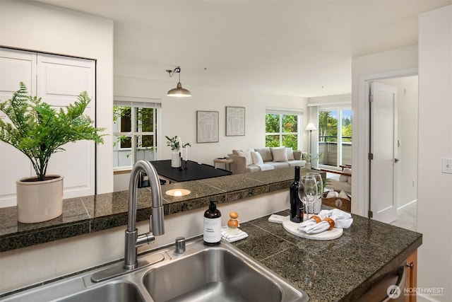 9057 Greenwood Ave N Unit 201, Seattle, WA 98103 - kitchen with tile counters, a sink, plenty of natural light, and open floor plan