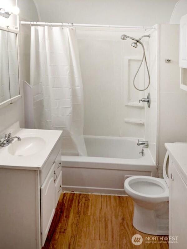 603 2nd St NW, Puyallup, WA 98371 - bathroom featuring vanity, shower / bath combo, wood finished floors, and toilet