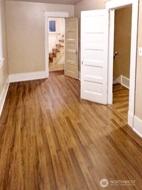 603 2nd St NW, Puyallup, WA 98371 - unfurnished bedroom with baseboards and wood finished floors