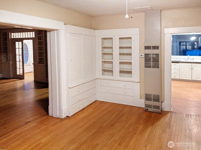 603 2nd St NW, Puyallup, WA 98371 - unfurnished dining area with a sink, light wood-style flooring, and a heating unit