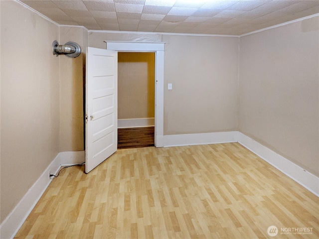603 2nd St NW, Puyallup, WA 98371 - unfurnished room with ornamental molding, light wood-style floors, and baseboards