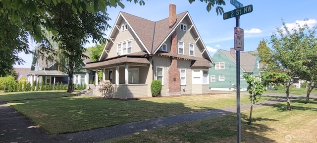 603 2nd St NW, Puyallup, WA 98371 - view of front facade with a front yard, brick siding, and roof with shingles