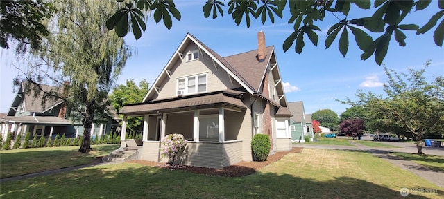 603 2nd St NW, Puyallup, WA 98371 - view of front of home with a front lawn, a chimney, covered porch, and roof with shingles