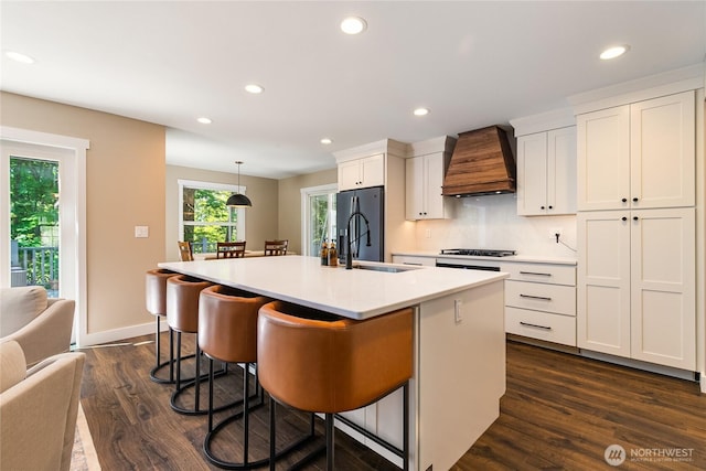 9111 Custer School Rd, Custer, WA 98240 - kitchen featuring custom range hood, recessed lighting, dark wood-style flooring, white cabinets, and a breakfast bar area