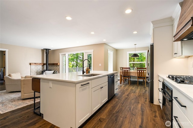 9111 Custer School Rd, Custer, WA 98240 - kitchen with a sink, black appliances, custom exhaust hood, open floor plan, and a wood stove