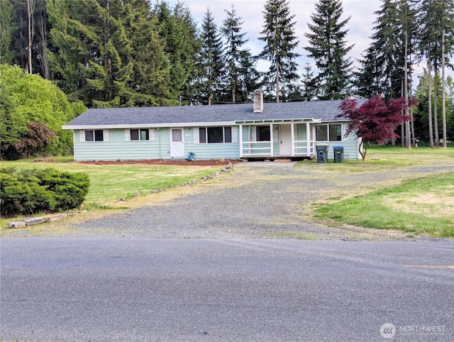 8927 178th Ave SW, Rochester, WA 98579 - ranch-style home with dirt driveway, a porch, a chimney, a front yard, and a shingled roof