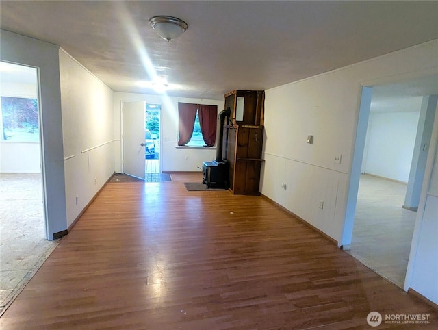 8927 178th Ave SW, Rochester, WA 98579 - unfurnished living room with a wood stove and wood finished floors