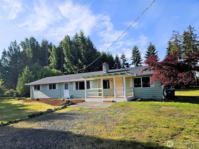 8927 178th Ave SW, Rochester, WA 98579 - view of front of home with covered porch, a front yard, and a chimney