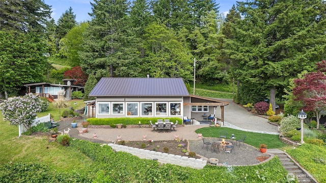 91 N Terrace Rd, Hoodsport, WA 98548 - rear view of house featuring a fire pit, a patio, and metal roof