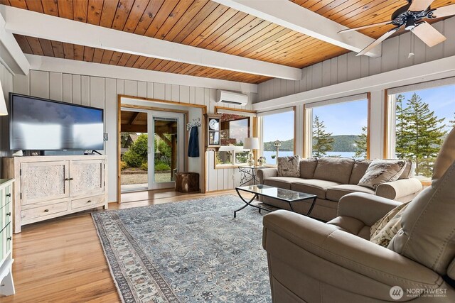 91 N Terrace Rd, Hoodsport, WA 98548 - living area with a wall mounted air conditioner, plenty of natural light, wood finished floors, wooden ceiling with exposed beams, and ceiling fan