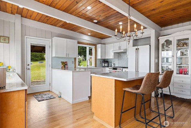 91 N Terrace Rd, Hoodsport, WA 98548 - kitchen with wood ceiling with exposed beams, stainless steel range with gas cooktop, freestanding refrigerator, backsplash, and light wood-style floors