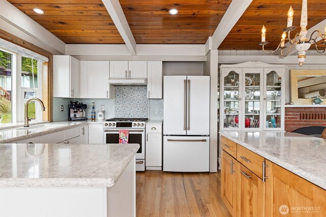 91 N Terrace Rd, Hoodsport, WA 98548 - kitchen featuring freestanding refrigerator, stainless steel range, under cabinet range hood, a sink, and light wood-style flooring