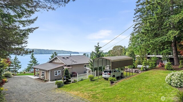 91 N Terrace Rd, Hoodsport, WA 98548 - view of front facade featuring gravel driveway, a detached carport, metal roof, and a water view