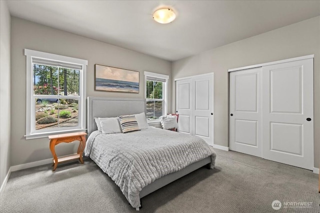 190 E Country Club Dr W, Union, WA 98592 - carpeted bedroom with baseboards, multiple windows, and multiple closets