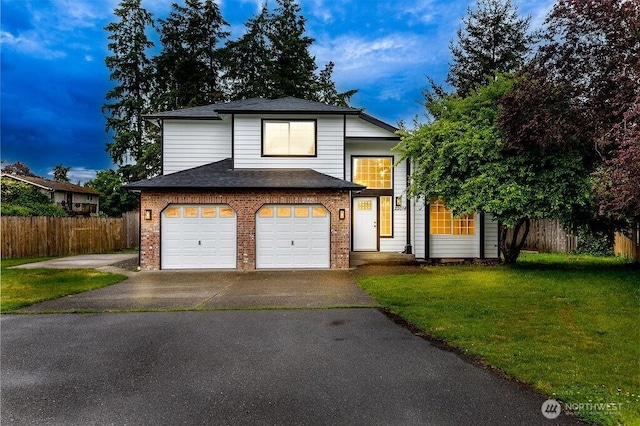 22014 48th Avenue Ct E, Spanaway, WA 98387 - traditional home with a garage, driveway, brick siding, and a shingled roof