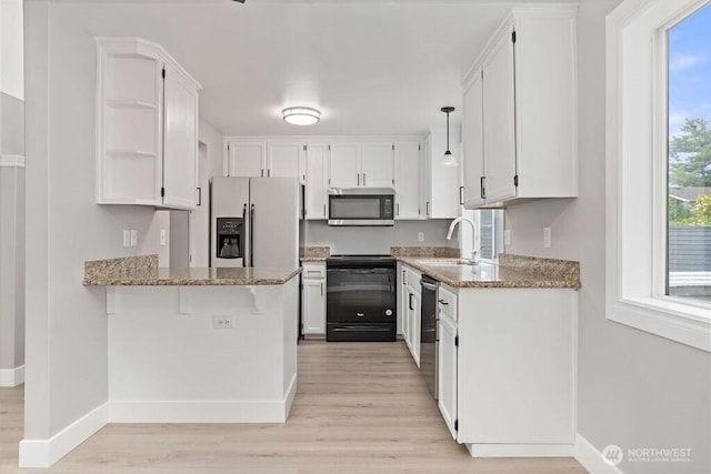 22014 48th Avenue Ct E, Spanaway, WA 98387 - kitchen featuring stainless steel appliances, open shelves, light wood-type flooring, and baseboards