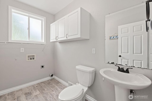 22014 48th Avenue Ct E, Spanaway, WA 98387 - half bathroom with baseboards, toilet, wood finished floors, and a sink
