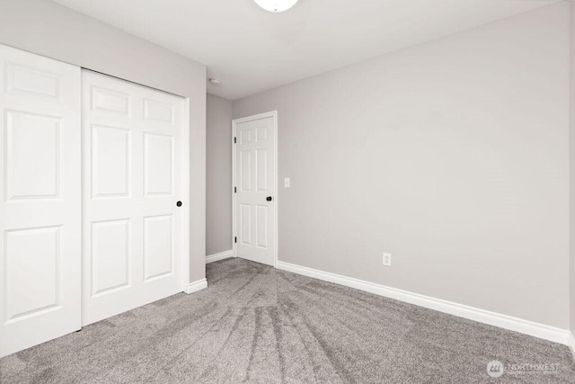 22014 48th Avenue Ct E, Spanaway, WA 98387 - unfurnished bedroom featuring carpet floors, baseboards, and a closet
