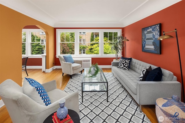 1605 E Olive St Unit 111, Seattle, WA 98122 - living room with wood finished floors, baseboards, and arched walkways