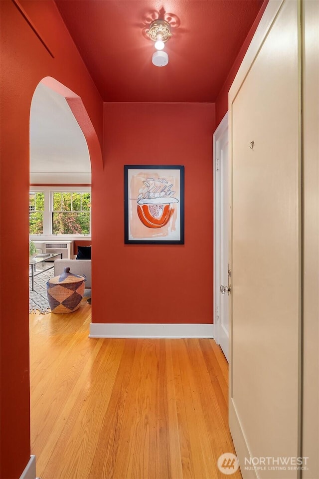 1605 E Olive St Unit 111, Seattle, WA 98122 - corridor with arched walkways, light wood finished floors, and baseboards