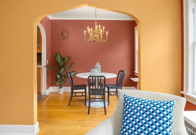 1605 E Olive St Unit 111, Seattle, WA 98122 - dining area with light wood-type flooring, a chandelier, and arched walkways
