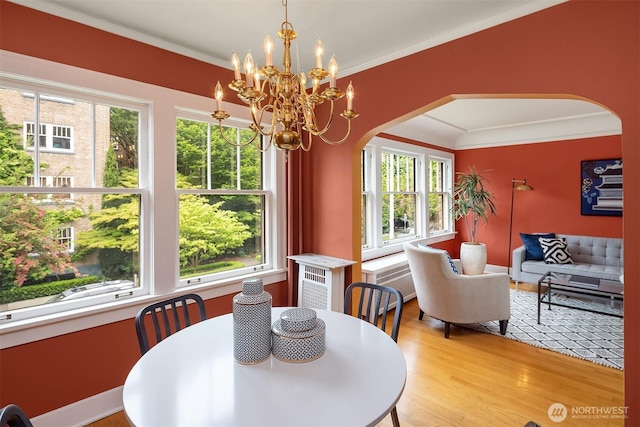 1605 E Olive St Unit 111, Seattle, WA 98122 - dining room with arched walkways, healthy amount of natural light, light wood-style flooring, and crown molding