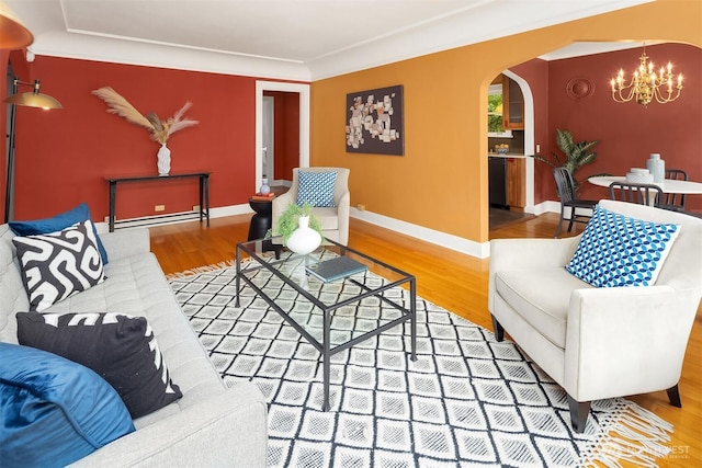 1605 E Olive St Unit 111, Seattle, WA 98122 - living room with a chandelier, arched walkways, wood finished floors, baseboards, and crown molding