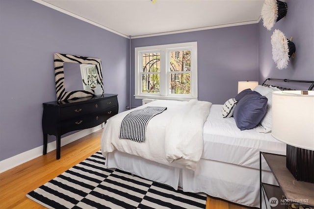 1605 E Olive St Unit 111, Seattle, WA 98122 - bedroom featuring wood finished floors, crown molding, and baseboards