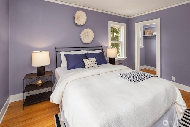 1605 E Olive St Unit 111, Seattle, WA 98122 - bedroom with light wood-style flooring, baseboards, ornamental molding, and a closet