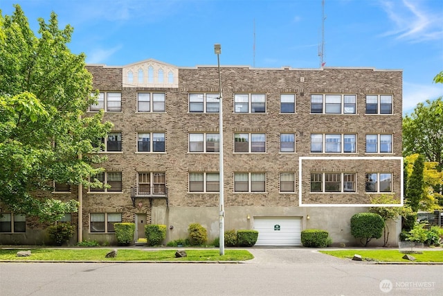 1605 E Olive St Unit 111, Seattle, WA 98122 - view of apartment building / complex featuring an attached garage and driveway