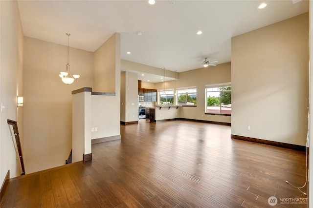 4020 NE 3rd Pl Unit B, Renton, WA 98056 - unfurnished living room with a ceiling fan, dark wood-type flooring, a chandelier, recessed lighting, and baseboards
