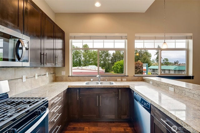 4020 NE 3rd Pl Unit B, Renton, WA 98056 - kitchen featuring a sink, appliances with stainless steel finishes, dark brown cabinetry, plenty of natural light, and recessed lighting