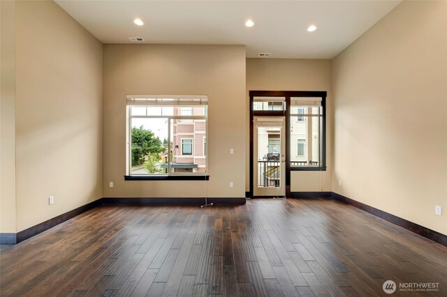 4020 NE 3rd Pl Unit B, Renton, WA 98056 - empty room featuring plenty of natural light, dark wood finished floors, recessed lighting, and baseboards