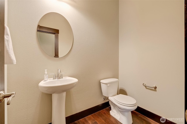 4020 NE 3rd Pl Unit B, Renton, WA 98056 - bathroom with wood finished floors, toilet, a sink, and baseboards