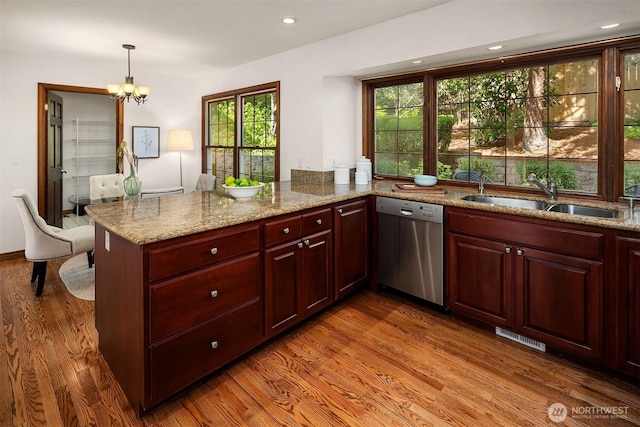 6220 146th Pl SE, Bellevue, WA 98006 - kitchen featuring stainless steel dishwasher, a sink, dark wood-type flooring, a peninsula, and light stone countertops