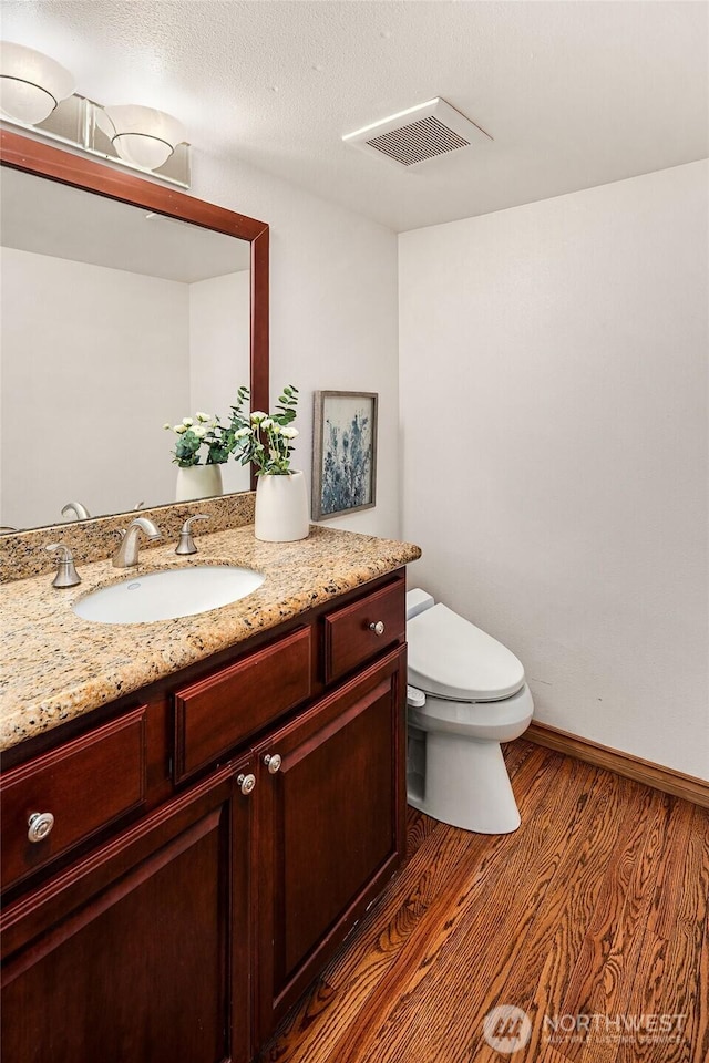 6220 146th Pl SE, Bellevue, WA 98006 - bathroom featuring toilet, vanity, wood finished floors, and baseboards