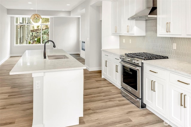 6726 NE 187th St Unit 104, Kenmore, WA 98028 - kitchen with a sink, wall chimney range hood, stainless steel range with gas stovetop, baseboards, and light wood-style floors