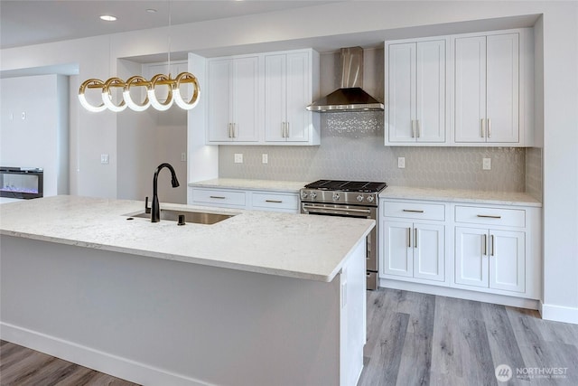 6726 NE 187th St Unit 104, Kenmore, WA 98028 - kitchen featuring wall chimney exhaust hood, stainless steel gas stove, a sink, light wood-type flooring, and recessed lighting