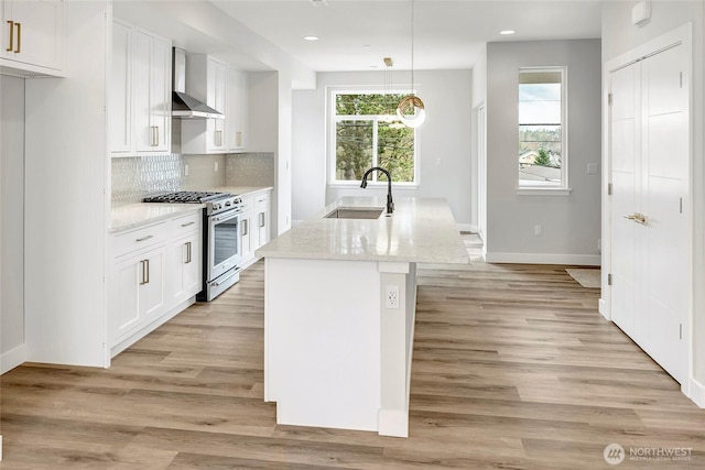 6726 NE 187th St Unit 104, Kenmore, WA 98028 - kitchen featuring stainless steel stove, wall chimney exhaust hood, a sink, white cabinetry, and recessed lighting