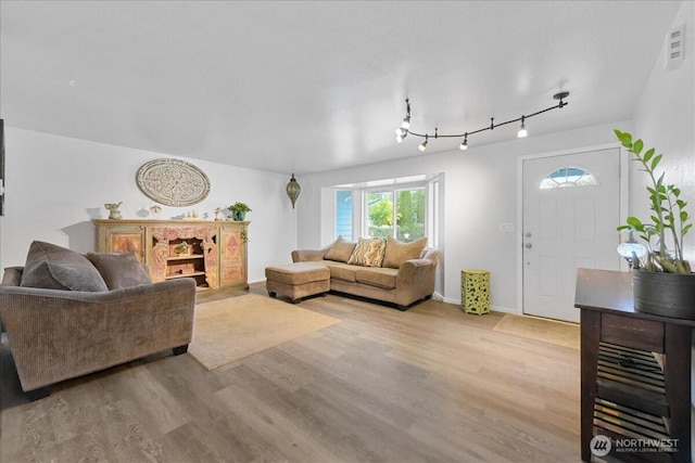32509 80th Dr NW, Stanwood, WA 98292 - living room featuring light wood-style floors, baseboards, and rail lighting